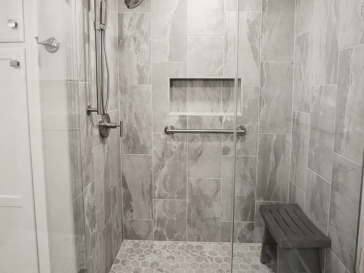 A beautiful tiled walk-in shower with a glass door