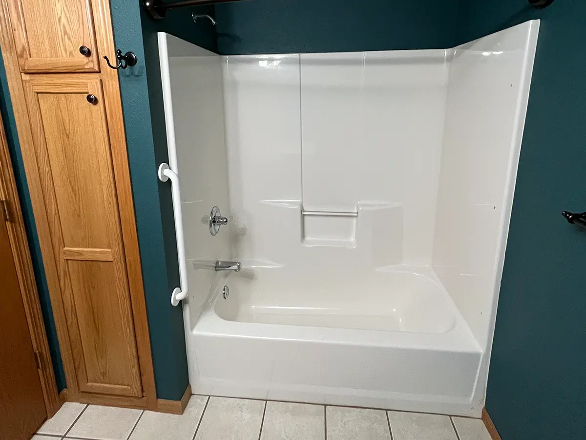 A tub and shower combo with a pan