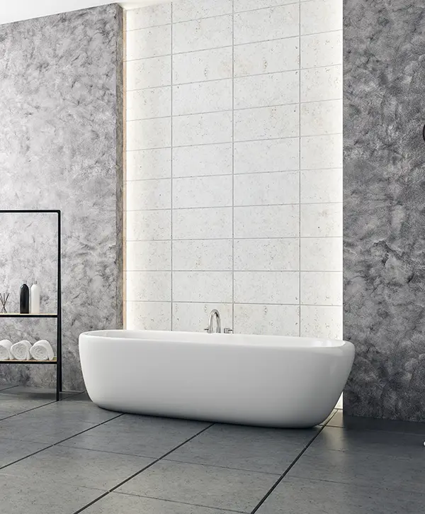 Freestanding tub on large tile flooring