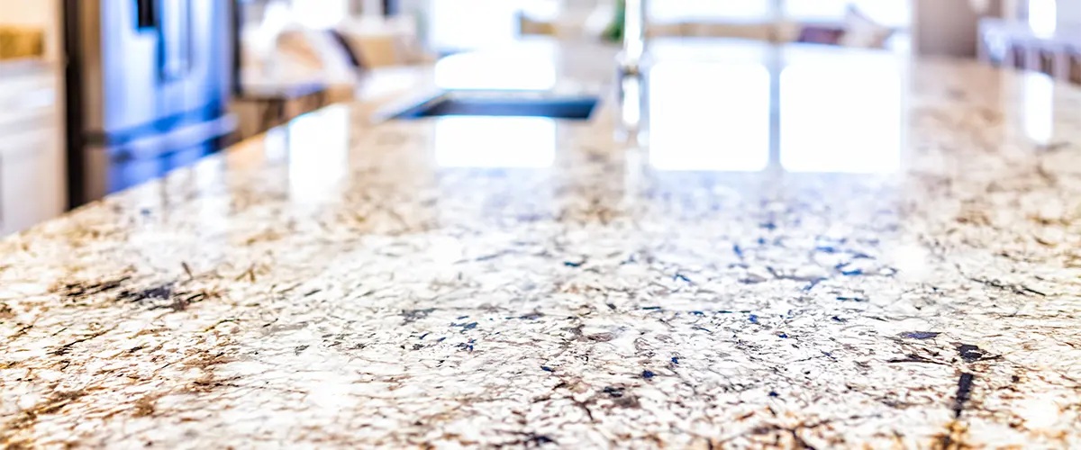 A granite countertop on a kitchen island