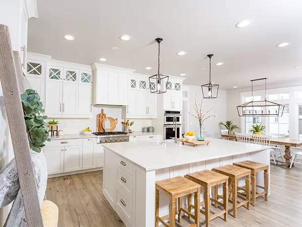 High-end kitchen remodel with island, new lighting, quartz counters, and beautiful cabinets