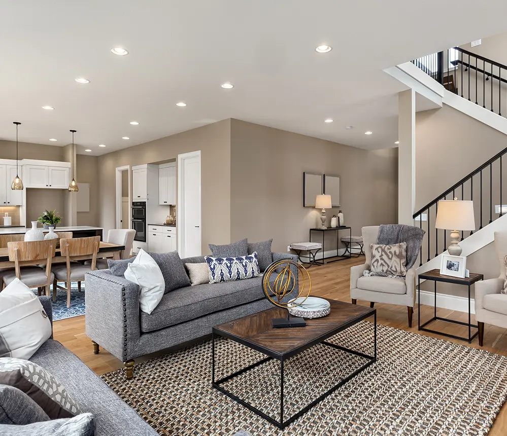 A gray couch in a living space with beige walls