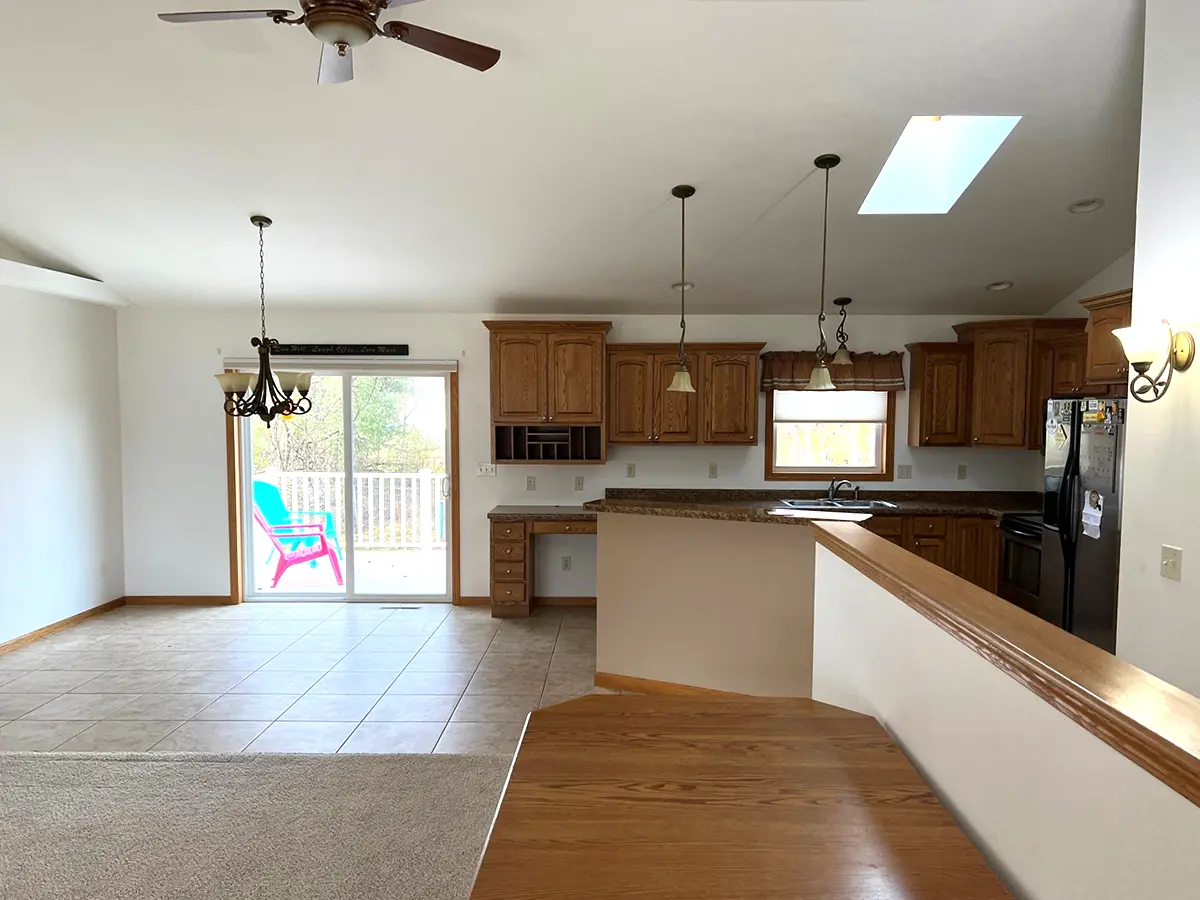 Wooden kitchen cabinets in a large space with ceramic flooring