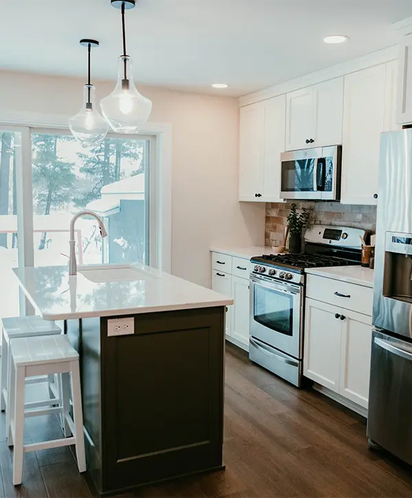 A kitchen remodeling in Schofield, WI, with lvp flooring and pendant lights