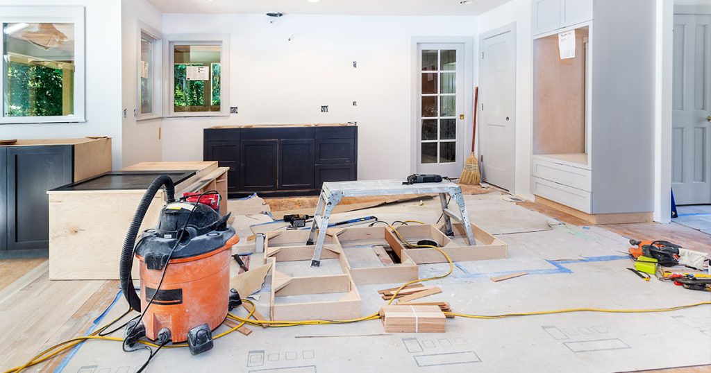 Kitchen remodeling site with materials spread all over the floor