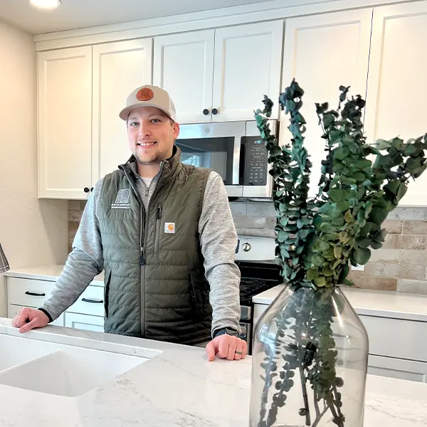 The owner of Remodeling Journey in a kitchen with white cainets