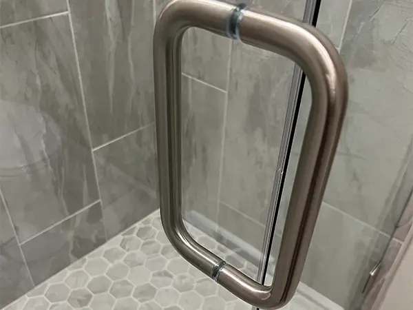 A handle for a shower glass door