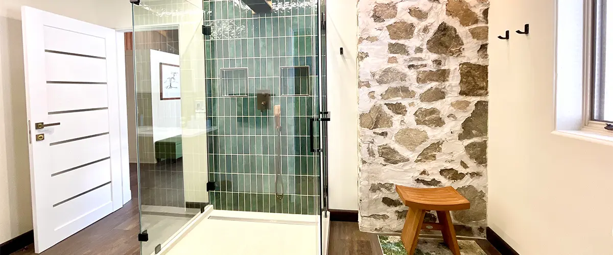 A beautiful shower with green tile backsplash