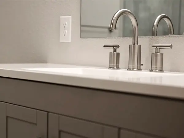 White countertop with a silver faucet