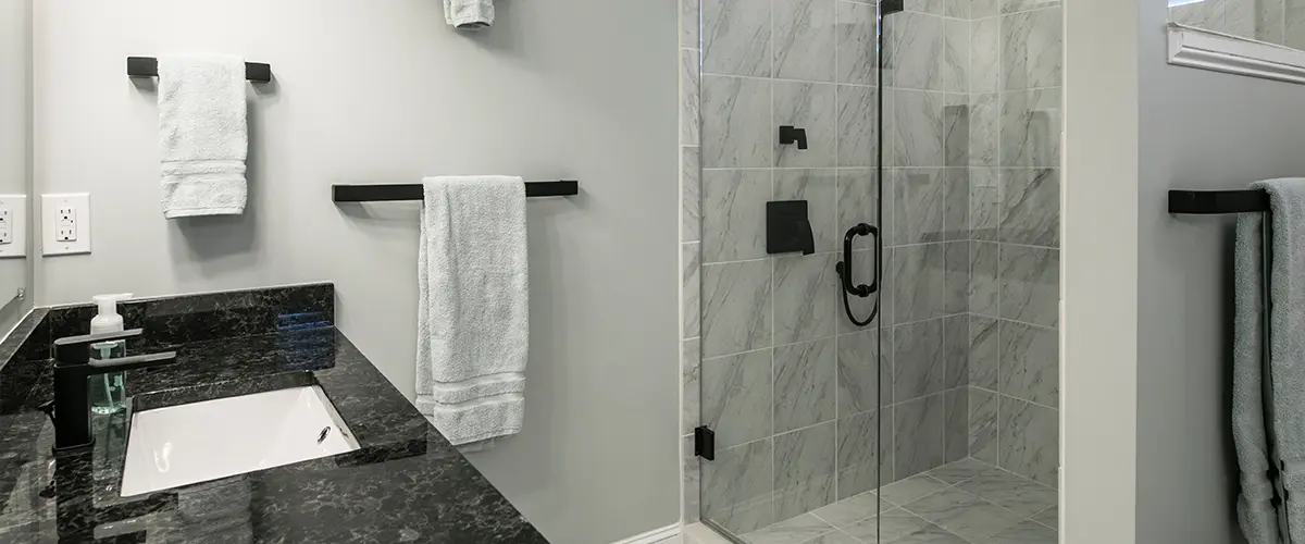 Glass walk-in shower with tile surround
