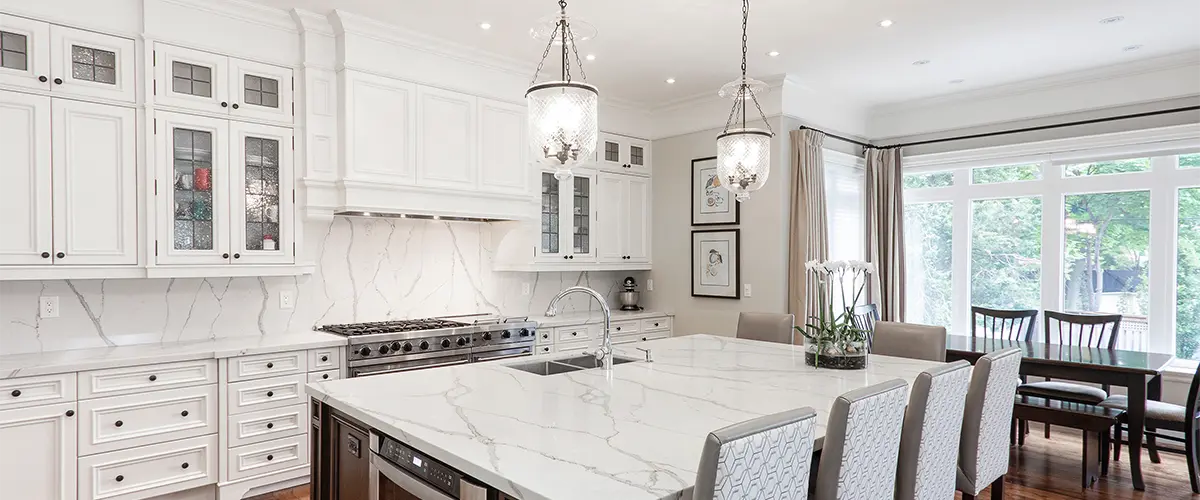 A large kitchen with a quartz top and white kitchen cabinets for a kitchen remodeling in Kronenwetter, WI