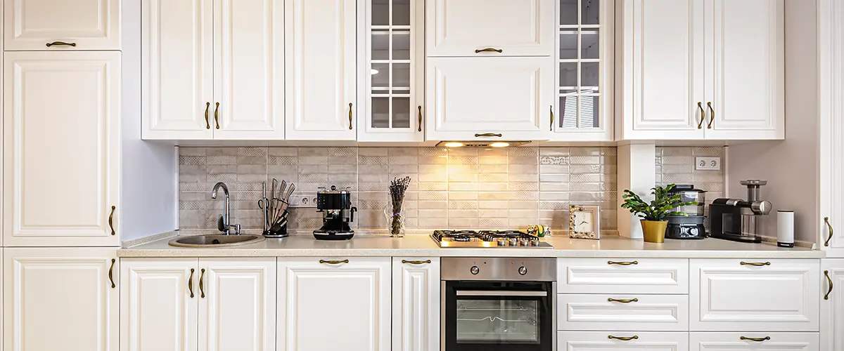 Replacing or refacing kitchen cabinets in a kitchen with white cabinetry and appliances