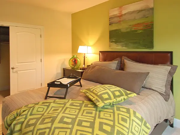 Guest bedroom with green bedsheets