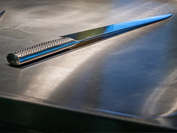 Stainless steel countertop with a knife on it