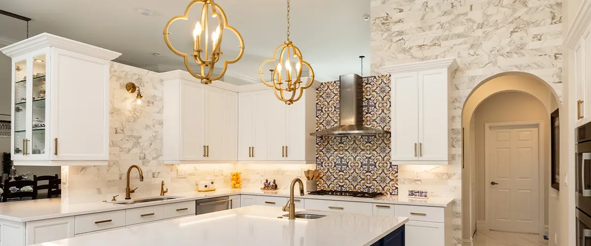 Modern white kitchen with golden accents.