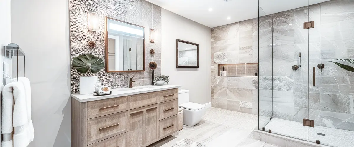 Elegant bathroom with wooden vanity, glass shower, and modern tile design