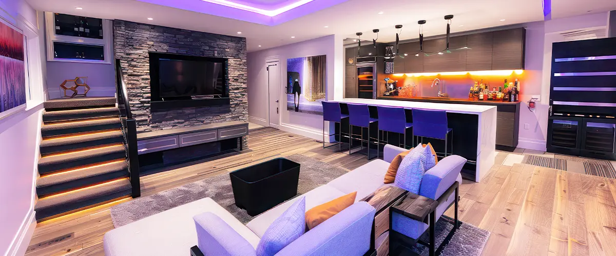 Stylish basement lounge with LED lighting, bar area, and modern staircase.