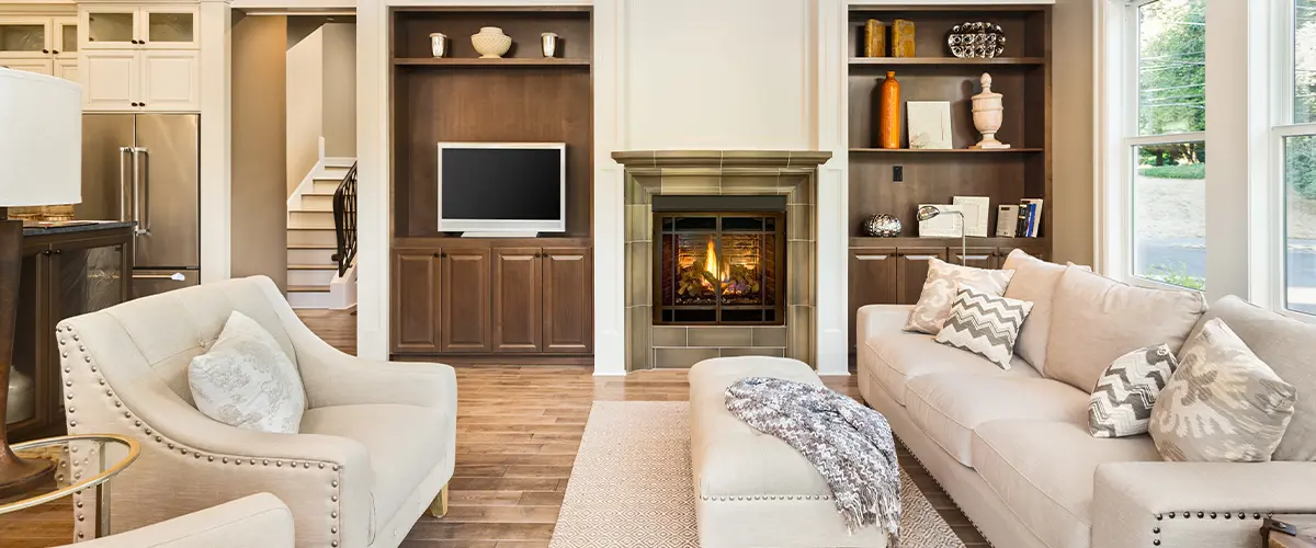 Elegant living room featuring a cozy fireplace, built-in shelving, and comfortable seating for a warm and inviting atmosphere.