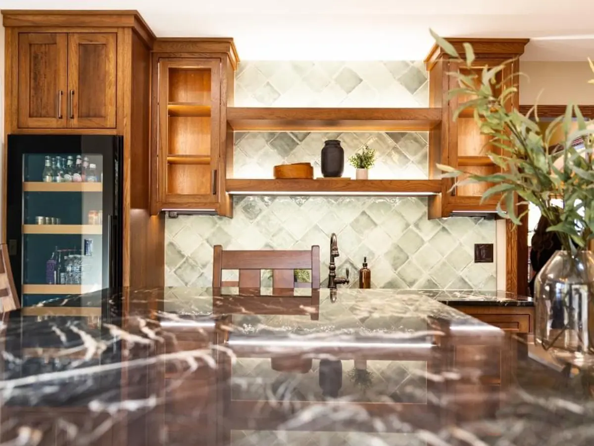 Close-up of modern kitchen with black marble countertop and open shelving