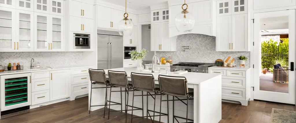 Luxury white kitchen with marble backsplash and large island