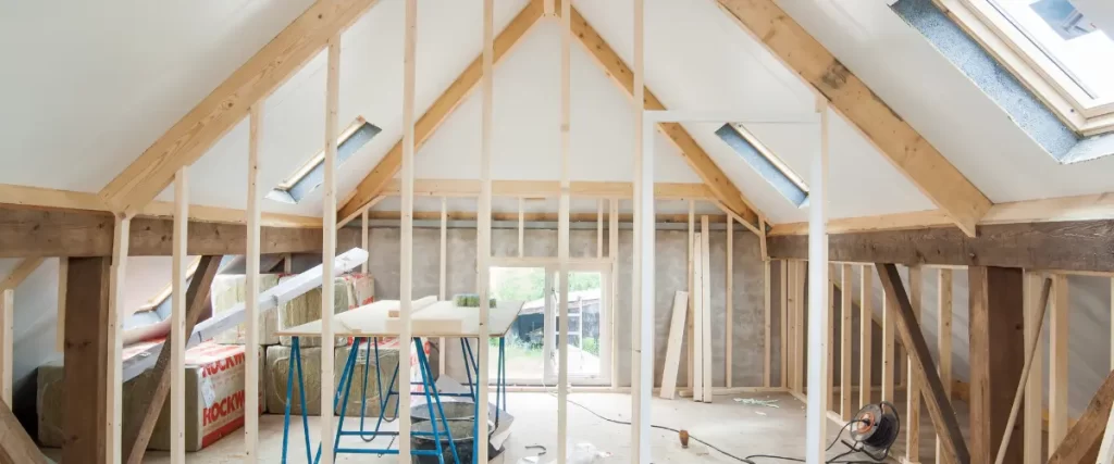 Framed attic space under construction with tools and workbench