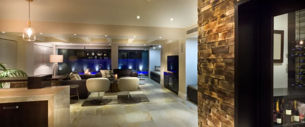 Modern basement entertainment area with seating and recessed lighting