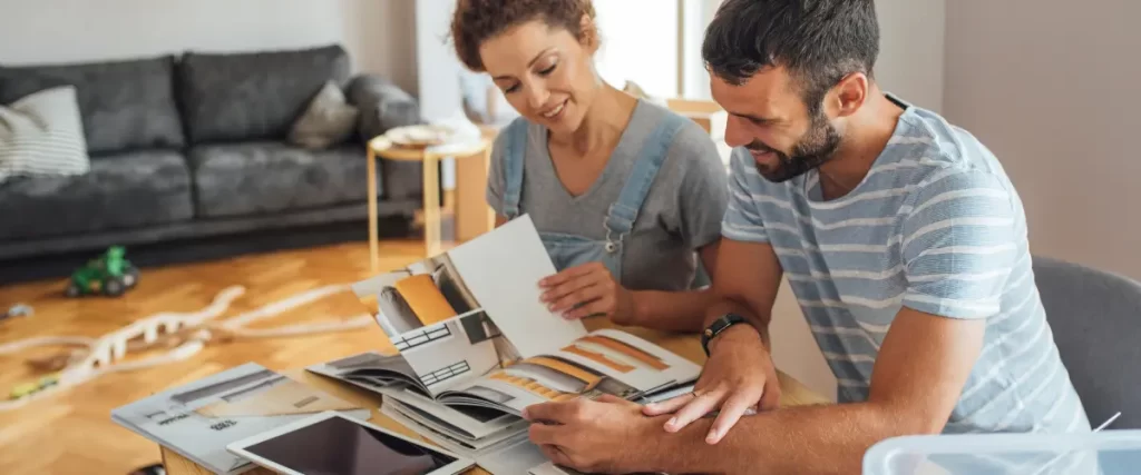 Couple discussing design plans with color samples in a living room