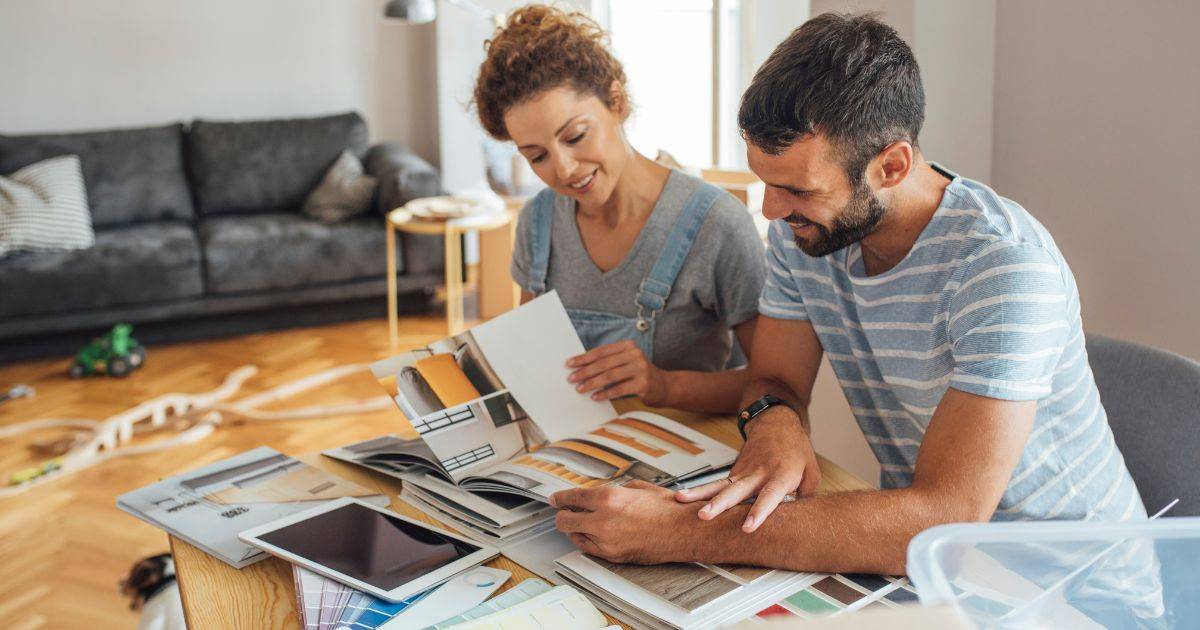 Couple reviewing color swatches and material samples for home renovation