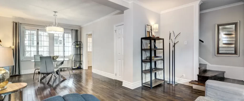 Bright modern hallway with white walls and dark hardwood floors