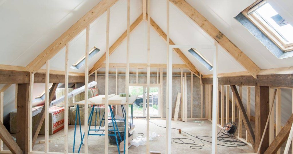 Interior construction site with exposed framing and tools
