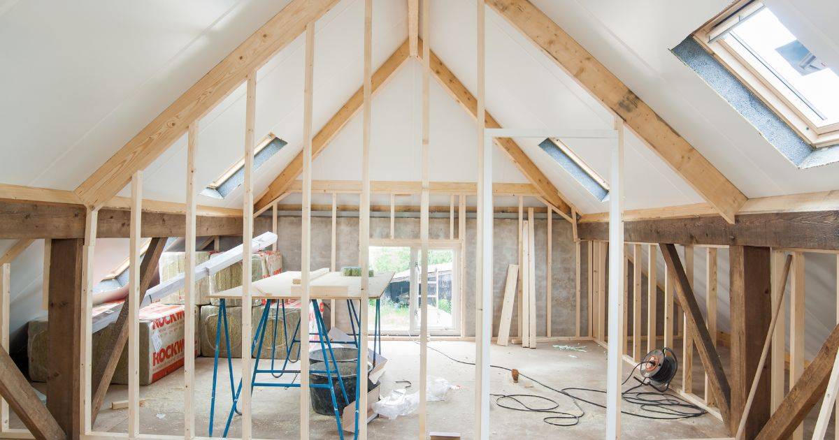 Interior construction site with exposed framing and tools
